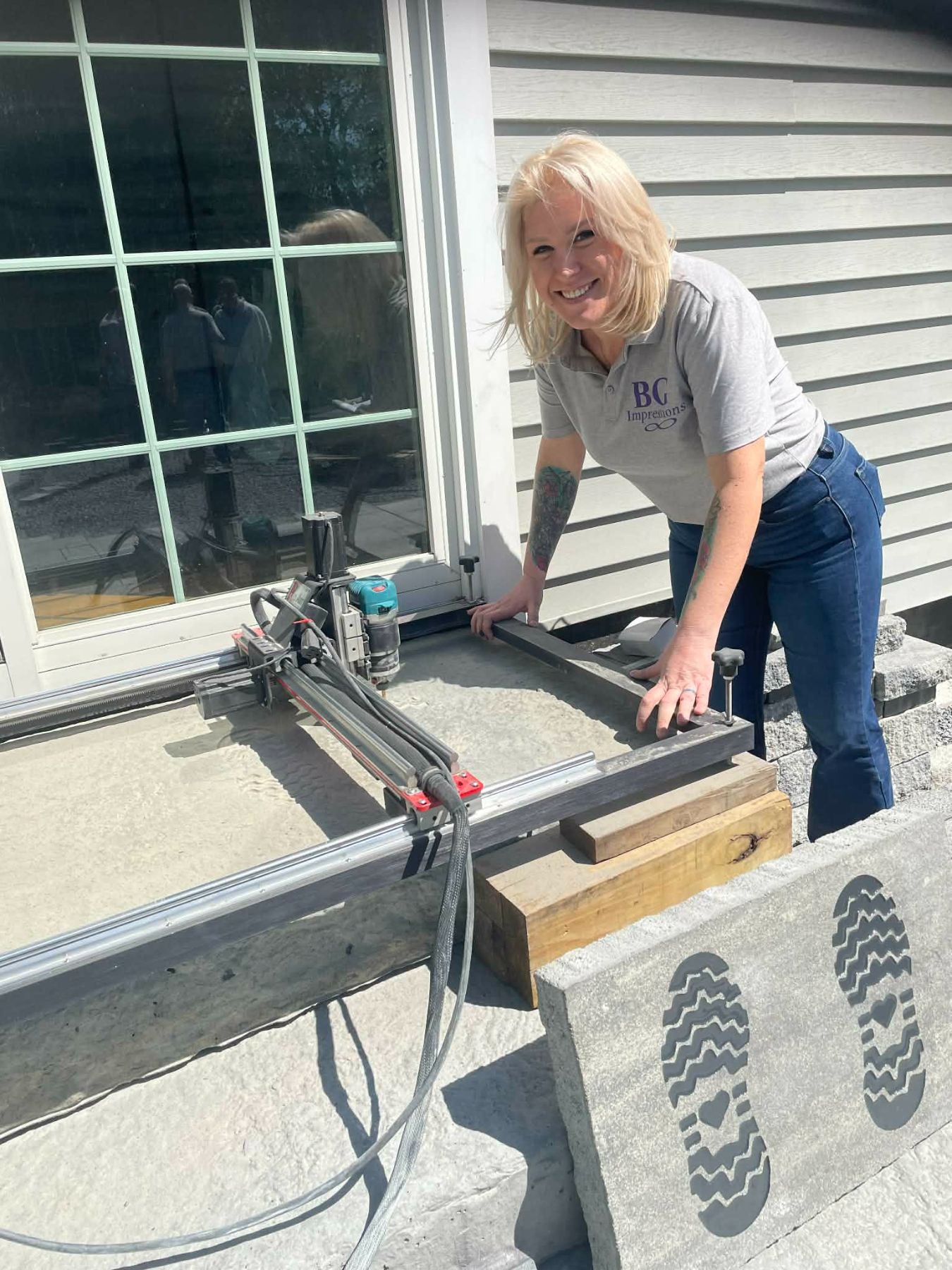 BG Impressions team member operating portable CNC engraving equipment on-site